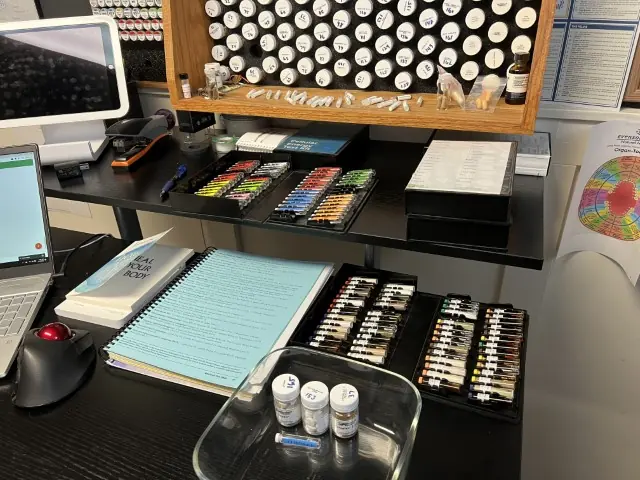 Rows of test vials and a binder of notes on the testing desk